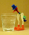 Drinking bird thermodynamic heat engine toy dipping toward water