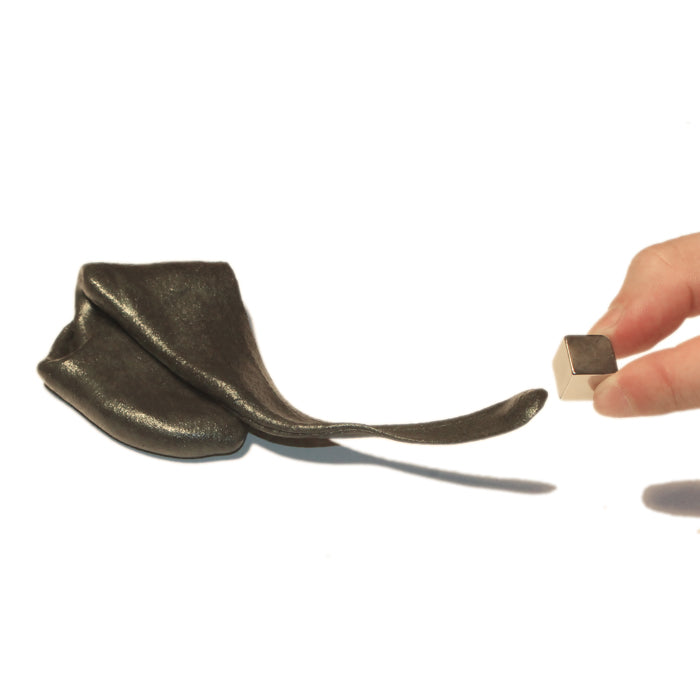 Magnetic putty slime reaching toward a magnet