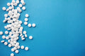 White potassium iodide tablets on blue background