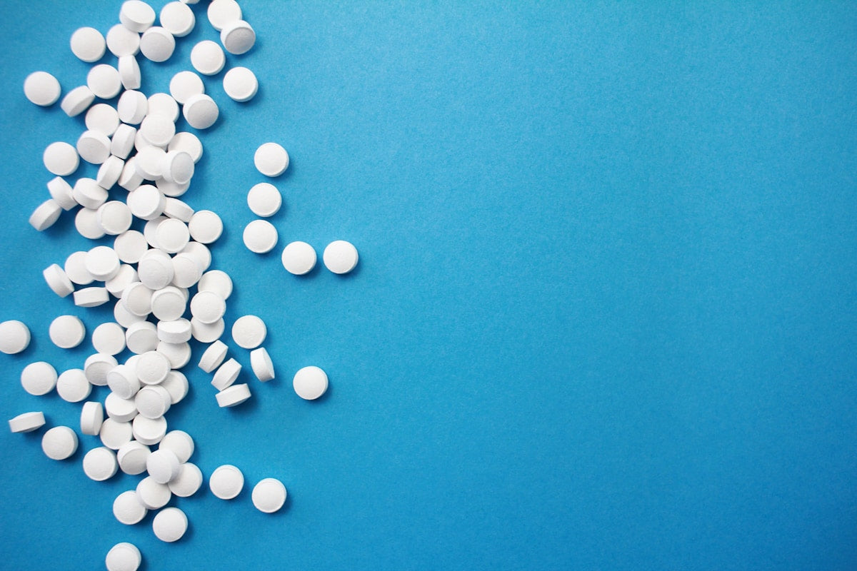 White potassium iodide tablets on blue background
