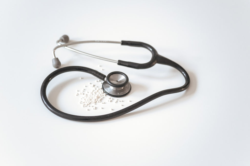 Stethoscope coiled on white surface