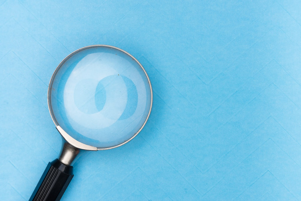 Clean magnifying glass on blue background