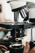 Close-up of compound microscope objective turret with multiple lenses