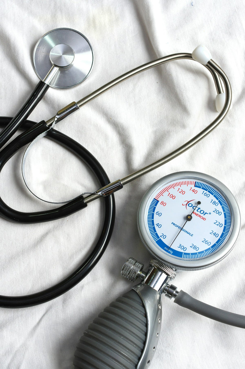 Aneroid sphygmomanometer with stethoscope on white cloth
