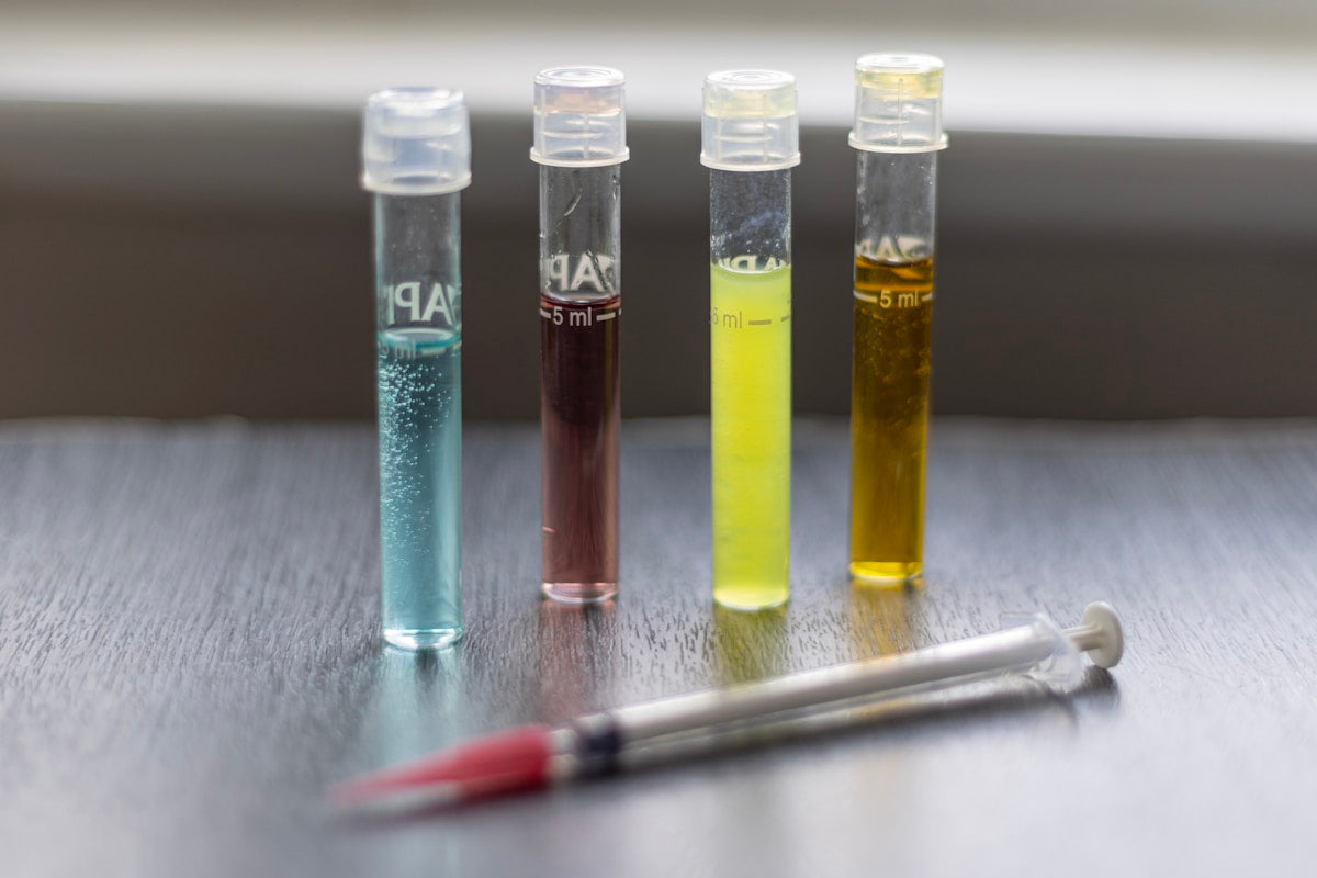 Colorful water quality test tubes with syringe in lab